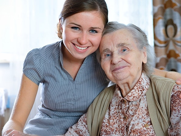 caregiver spending time with elderly woman